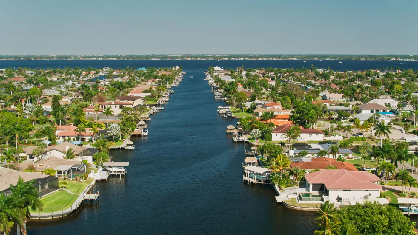Aerial of a Cape Coral canal lined with homes running out to the river