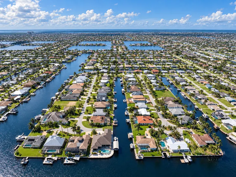 Aerial view of canal homes with docks and pools in Southeast Cape Coral